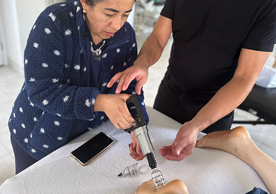 teaching-a-cupping-therapy-session-on-a-patient's-foot.