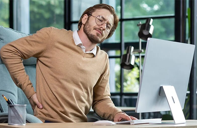 back pain at work – corporate massage therapy is a key part of successful corporate wellness programs